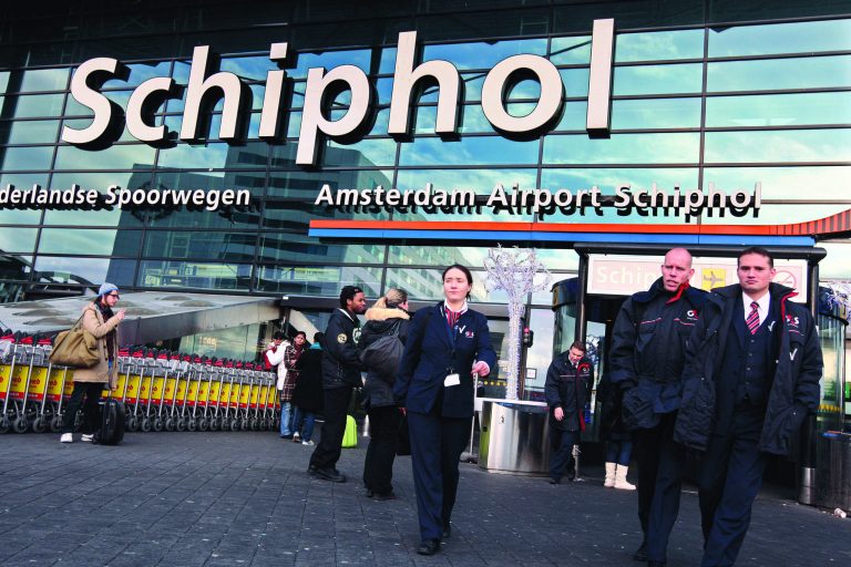 FILE This Saturday Dec. 26, 2009 file photo shows security workers leave Schiphol airport in Amsterdam, Netherlands. Police at Amsterdam's Schiphol Airport have opened a criminal investigation into how needles got into turkey sandwiches served to passengers on Delta Air Lines flights from Amsterdam to the United States, a spokesman said Tuesday July 17, 2012. The FBI also is investigating the incidents. Delta said what appear to be sewing needles were found in five sandwiches on Sunday July 15, 2012. One passenger on a flight to Minneapolis was injured. The other needles were on two flights to Atlanta and one to Seattle. (AP Photo/Evert Elzinga)