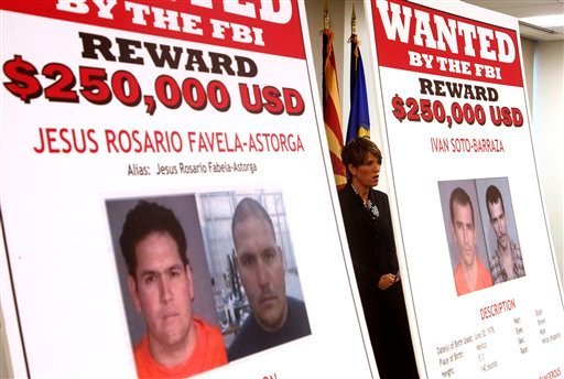 Laura E. Duffy, United States Attorney Southern District of California, is flanked by wanted posters as she speaks at a news briefing where Duffy announces the indictment of five suspects related to the death of U.S. Border Patrol agent Brian Terry, Monday, July 9, 2012, in Tucson, Ariz.  A reward of up to $1 million dollars for information leading to the arrest of  four fugitives was also announced by Department of Justice officials, on suspect is in custody.(AP Photo/Ross D. Franklin)