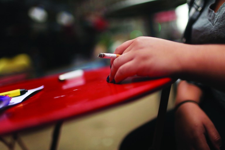 NEW YORK - SEPTEMBER 16:  A woman smokes in a Times Square pedestrian island on September 16, 2010 in New York City. New York City Mayor Michael Bloomberg has proposed a ban on smoking in city parks, beaches, and parts of Times Square. Citing the danger of second hand smoke, the mayor sees the proposal as an extension of a popular public smoking ban in 2002 in workplaces and a ban in 2003 in restaurants and bars.  (Photo by Spencer Platt/Getty Images)