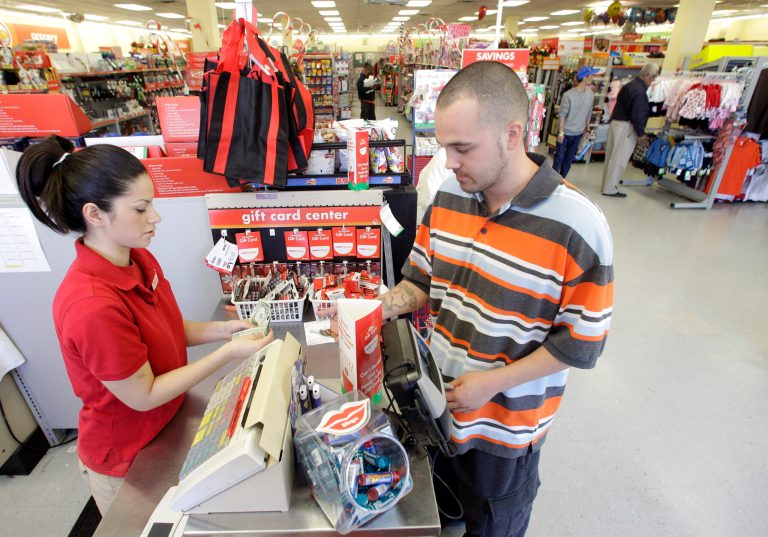 FILE - In this file photo taken Dec. 14, 2010, Family Dollar employee Pamela Ramos, left, assists John Conner with a purchase at a store in Waco, Texas. Family Dollar on Thursday, April 10, 2014 said it will be cutting jobs and closing about 370 underperforming stores as it looks for ways to improve its financial performance. It says it will also cut prices on about 1,000 basic items. (AP Photo/Tony Gutierrezfile, File)