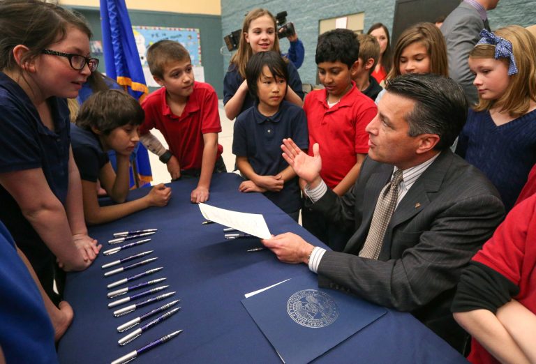 Nevada Gov. Brian Sandoval talks with a group of Carson City fifth-graders in Carson City, Nev., on Wednesday, March 4, 2015. The governor is expected to to sign into law an education savings account bill, which has passed both chambers of the Nevada Legislature with only Republican support.Â (AP Photo)