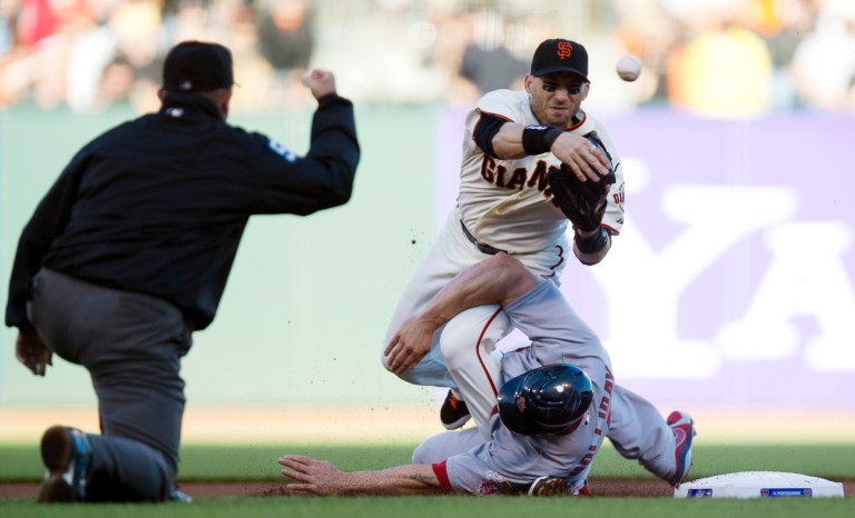 Paul Kitagaki Jr./AP Photo/The Sacramento Bee
San Francisco Giants second baseman Marco Scutaro was taken out by St. Louis Cardinals' Matt Holliday during Game 2 of the NLCS on Monday.