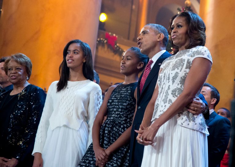 The first family, including Marian Robinson, from left, Malia Obama, Sasha Obama, President Obama, and first lady Michelle Obama, sing Christmas carols on stage during the annual 2013 Christmas in Washington presentation in Washington on Dec. 15. (AP Photo/Manuel Balce Ceneta)