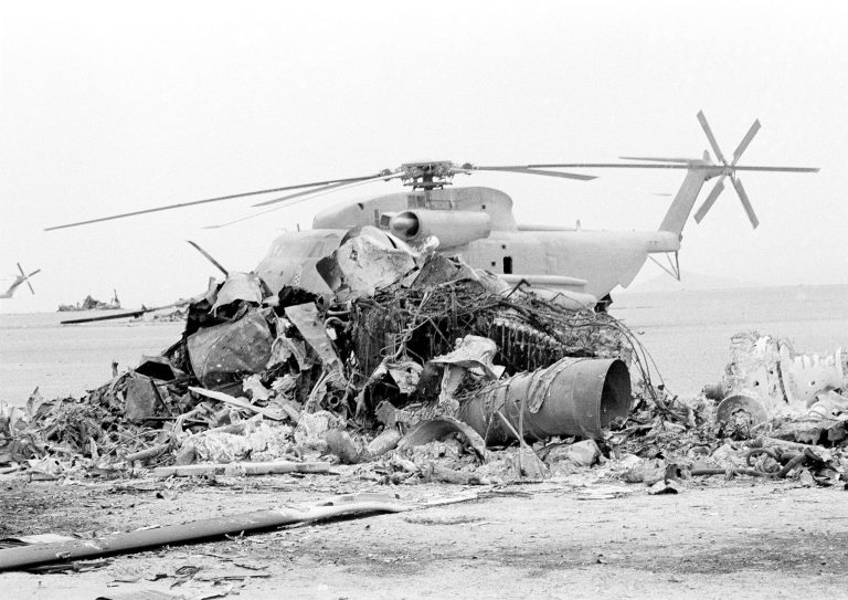 An undamaged helicopter sits on the ground behind the charred remains of a second U.S. helicopter in the Iranian desert of Dasht-E-Kavir, April 26, 1980, the remains of the failed Operation Eagle Claw raid to try to free the American hostages in Iran. The site, about 300 air miles from Tehran, was where the U.S. hostage rescue effort was abandoned, and where a U.S. helicopter and transport collided. (AP Photo)