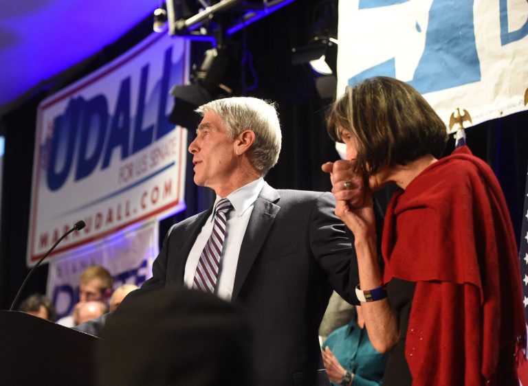 U.S. Senator Mark Udall's wife, Maggie Fox, kisses Udall's during his concession speech on election night, Tuesday, Nov. 4, 2014 in Denver. Udall lost his seat to Republican Cory Gardner. (AP Photo/The Gazette, Jerilee Bennett)