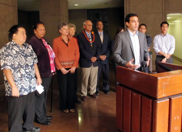 Rep. Chris Lee speaks to journalists from a lectern at the Hawaii Capitol in Honolulu on Monday, Jan. 27, 2014. Lee is one of several lawmakers suggesting any fines or settlements the state collects for ocean spills be put toward restoring coral reefs. (AP Photo/Oskar Garcia)