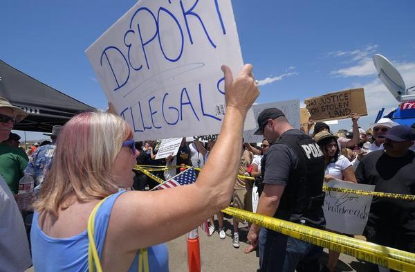 A demonstrator that opposes illegal immigration shouts at immigration supporters, July 4, outside a U.S. Border Patrol station in Murrieta, Calif. AP/Mark J. Terrill