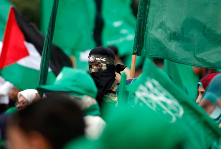 Tens of thousands of Hamas supporters attend a rally to commemorate the 10-year anniversary of the assassination of the group's spiritual leader Sheik Ahmed Yassin in an Israeli airstrike a decade ago, in Gaza City, Sunday, March 23, 2014. (AP Photo/Hatem Moussa)