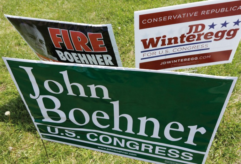 Campaign signs for Speaker John Boehner and one of his opponents, J.D. Winteregg, are posted on a road leading to a polling location, Tuesday, May 6, 2014, in West Chester, Ohio. (AP Photo/Al Behrman)