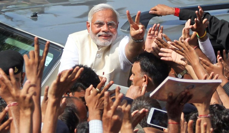 India's main opposition Bharatiya Janata Partyâs prime ministerial candidate Narendra Modi displays the victory symbol to supporters after casting his vote in Ahmadabad, India, Wednesday, April 30, 2014. Modi's carefully crafted and well-financed campaign presents him as a can-do politician who has turned his home state of Gujarat into a haven for business and industry, and has pledged to bolster India's growth. His image has been tainted by the 2002 sectarian violence that ripped through his home state, killing nearly 1,000 Muslims. Modi, who has been chief minister of the state since 2001, is widely seen as doing little to stop the violence, and his fiercest critics have accused him of organizing the bloodshed. (AP Photo/Ajit Solanki)