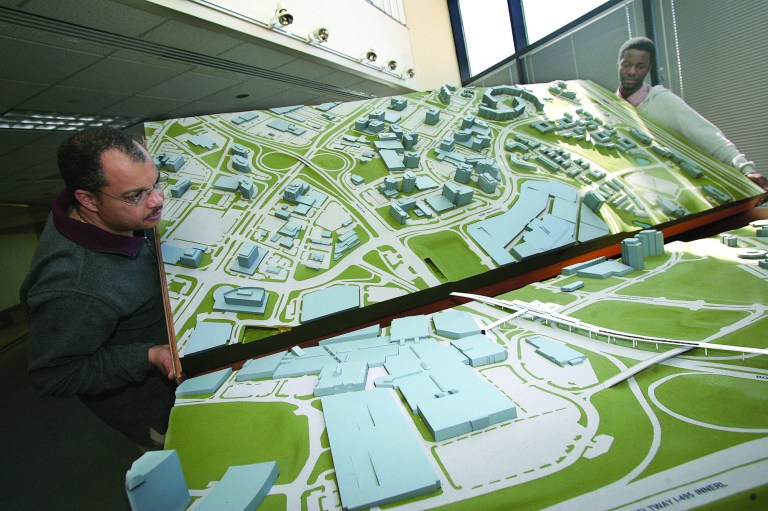 Way back when: Peter Scott (left) and Yusuf Bangura (right) assemble a model of the impending Metrorail right of way through the Tysons Corner area of Fairfax County in 2006. (Photo: Brig Cabe/Washington Examiner)