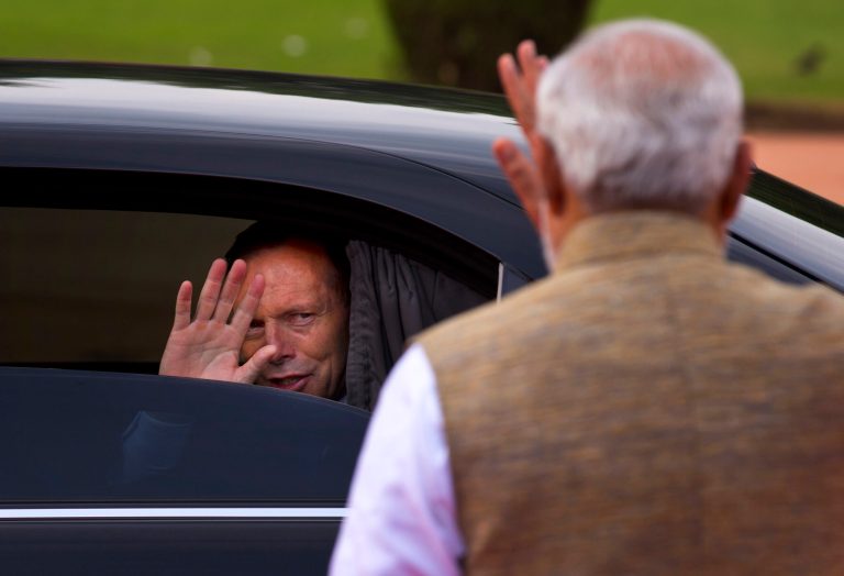 Australian Prime Minister Tony Abbott, left, waves at his Indian counterpart Narendra Modi as he leaves after a ceremonial welcome in New Delhi, India, Friday, Sept. 5, 2014. Abbott is on a two-day visit to India. (AP Photo/Saurabh Das)