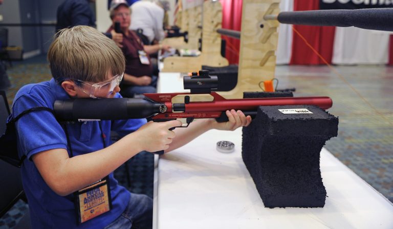 Drew Clukey,11, from Alabama takes a turn at shooting an air gun at the 