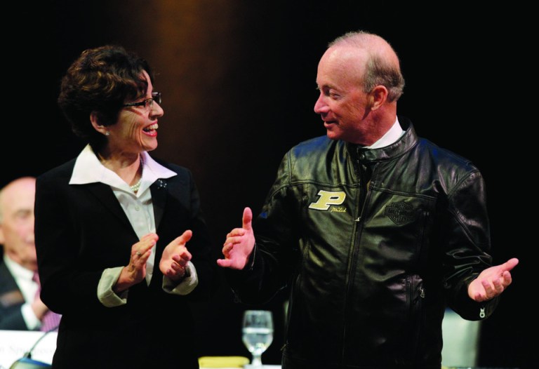 Indiana Gov. Mitch Daniels displays his new Purdue leather jacket given to him by the board of trustee to current Purdue University president France Cordova after he was named as the next president of Purdue University by the school's trustees in West Lafayette, Ind., Thursday, June 21, 2012. Daniels will take the helm of the school after leaving office in January and succeeds Cordova who will leave in July after five years at Purdue's helm. (AP Photo/Michael Conroy)