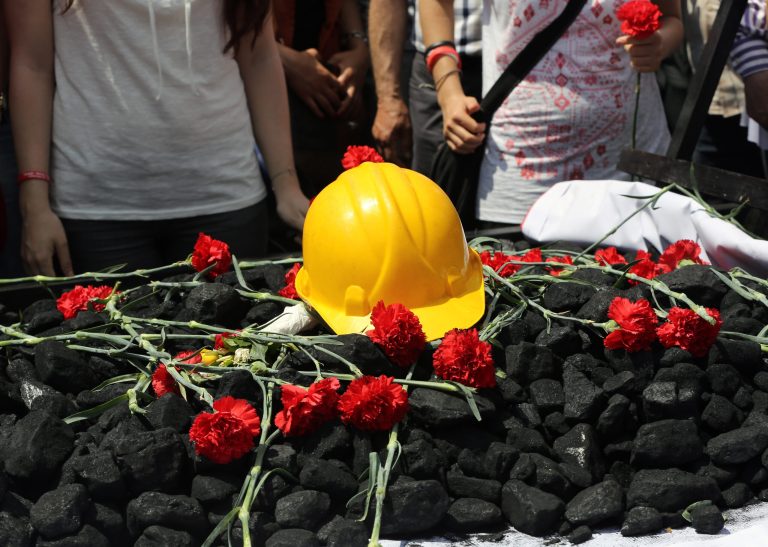 People place flowers on some coal and a hard hat as nearly 2,000 university students called on the government to resign as they marched to commemorate the beginning of the Turkish War of Independence started on May 19, 1919, in Ankara, Turkey, Monday, May 19, 2014. Government officials have promised to investigate and pledged that any mine officials found to be negligent would be punished. Still the disaster has provoked anger at a critical time for Prime Minister Recep Tayyip Erdogan, as he mulls running in August's presidential election. (AP Photo/Burhan Ozbilici)