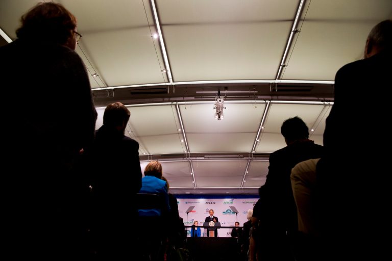 A crowd and Sen. Elizabeth Warren listen as President Barack Obama speaks at AARP in Washington, Monday, Feb. 23, 2015. (AP Photo)Â 