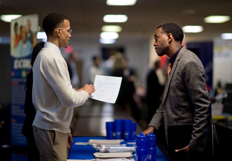 FILE - In this Thursday, Nov. 14, 2013, file photo, retired U.S. Air Force Master Sgt. Thomas Gipson, of Atlanta, right, has his resume looked over by Ralph Brown, a management and program analyst with the Centers for Disease Control and Prevention, during a job fair for veterans at the VFW Post 2681,Marietta, Ga. The government reports on state unemployment rates for March on Friday, April 18, 2014. (AP Photo/David Goldman, File)