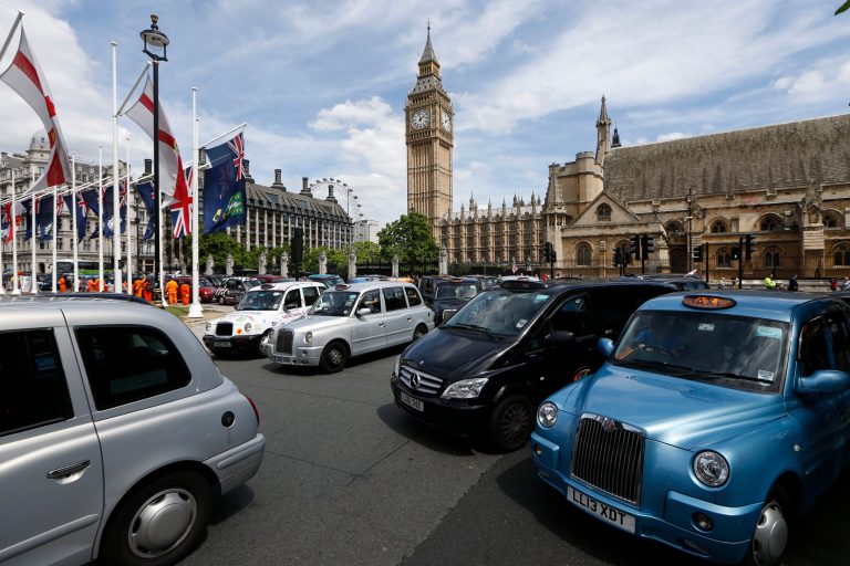 Taxi stand still at Parliament Square in central London as thousands of London black cabs blocking the streets to protest over new technology they say endangers passengers, in London, Wednesday, June 11, 2014.  The strike action by taxi drivers hit many European cities, Wednesday, sparked by fears about the growing upheaval in the travel and transport industry, largely due to digital technologies. Big Ben's clock tower back centre. (AP Photo/Sang Tan)