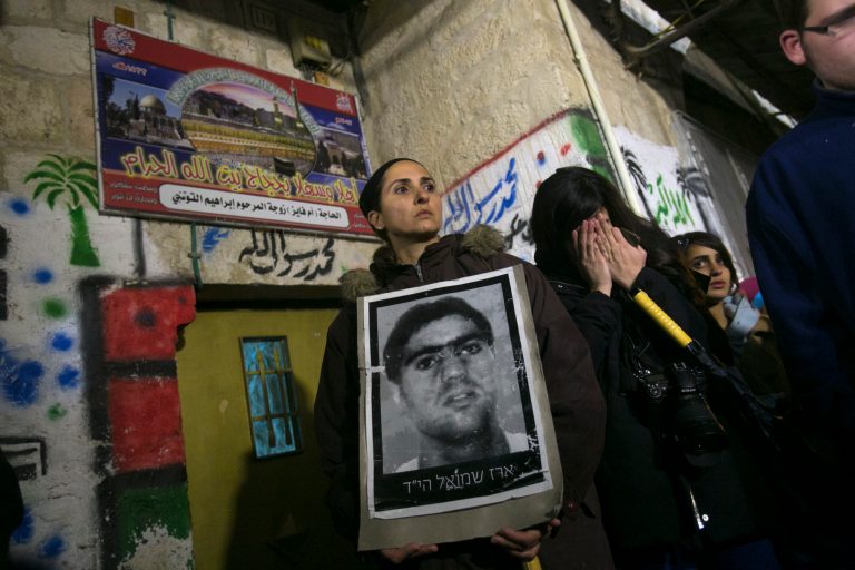 Relatives of Israelis killed in attacks by Palestinian militants, hold photos of victims during a demonstration against the release of 26 long-serving Palestinian prisoners, in Jerusalem's old city, Monday, Dec. 30, 2013. Israel and the Palestinians are gearing up for the expected release by Israel of 26 of the longest-serving Palestinian prisoners. Israel has agreed to release the men, who were all convicted in deadly attacks of Israelis, as part of a U.S.-brokered package to restart peace talks. (AP Photo/Olivier Fitoussi) ISRAEL OUT