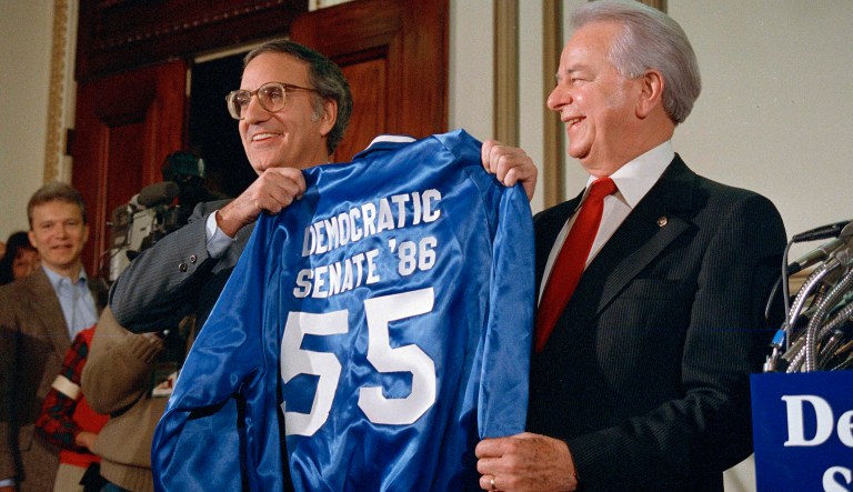 Sen. George Mitchell, D-Maine, left, presents a jacket imprinted with the words 