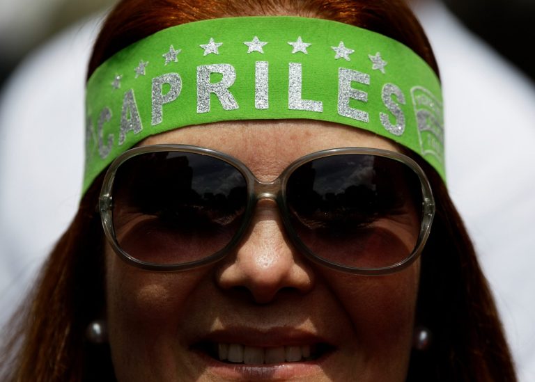 An opposition protester wears a bandana that reads in Spanish 