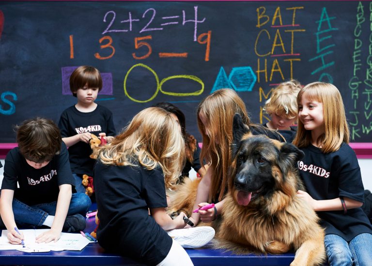 Children share time with canine mascot Johnny Cash at the TutorVille HUB in Houston. (AP/Josh Welch)

