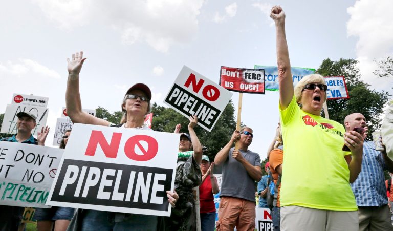 Opponents of a proposed natural gas pipeline protest on Boston Common across from the Statehouse in Boston, Wednesday, July 30, 2014. Energy company Kinder Morgan has proposed the $3.75 billion extension of its northeast pipeline through Massachusetts and says will provide clean-burning natural gas to the northeast. (AP Photo/Charles Krupa)