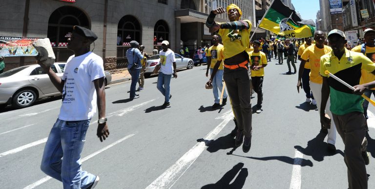 Ruling party African National Congress, supporters carry rocks and stones as they attempt confronting Democratic Alliance members, in Johannesburg, South Africa, Wednesday, Feb. 12, 2014. The skirmish happened Wednesday after followers of the opposition Democratic Alliance marched near the headquarters of the African National Congress, which has dominated politics since the end of white minority rule in 1994. (AP Photo)
