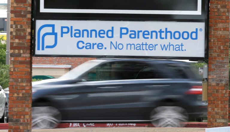 Traffic passes a Planned Parenthood sign in Dallas, Texas. (AP Photo/LM Otero)