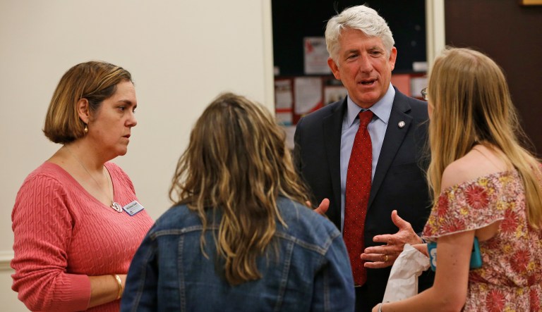 This Wednesday Oct. 4, 2017 photo, Virginia Attorney General Mark Herring talks with University of Richmond students and Democratic candidate for the 56th House of Delegates seat, Melissa Dart (pictured left). (AP Photo/Steve Helber)