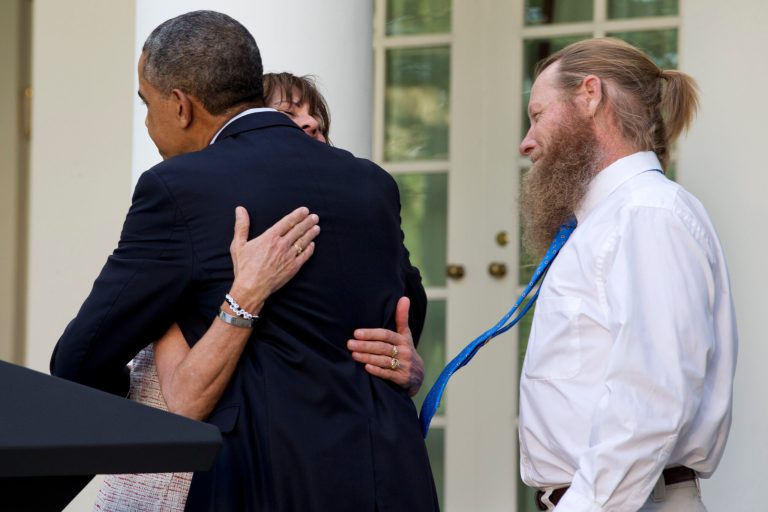 Jani Bergdahl, left, with her husband Bob Bergdahl, right, embraces President Obama after he spoke about the release of their son, U.S. Army Sgt. Bowe Bergdahl, in the Rose Garden of the White House May 31. (AP Photo/Jacquelyn Martin)