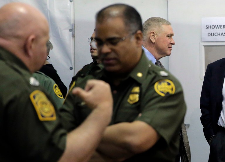 U.S. Customs and Border Protection chief Gil Kerlikowske stands with agents as he waits to address the media at a temporary holding facility, Wednesday, Dec. 7, 2016, in Donna, Texas. The tent facility is primarily being used as a temporary holding site for children and family units who have entered the county illegally. Kerlikowske said the number of apprehensions along the southwestern border can be close to 2,000 a day, with most people turning themselves in. (AP Photo/Eric Gay)