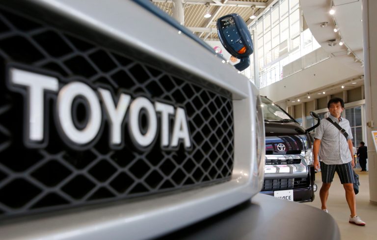 A visitor walks around a Toyota showroom in Tokyo, Tuesday, Aug. 5, 2014. Toyota Motor Corp. reported a better-than-expected rise in quarterly profit as vehicle sales grew in North America and Europe, offsetting a drop in Japan. (AP Photo/Shizuo Kambayashi)