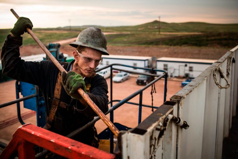 A floor hand for Raven Drilling works on an oil rig drilling into the Bakken shale formation outside Watford City, N.D. (Andrew Burton/Getty Images)