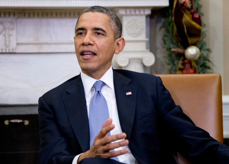 President Barack Obama speaks to the media as he first lady Michelle Obama meet with a group of mothers in the Oval Office of the White House in Washington, Wednesday, Dec. 18, 2013, to discuss how health care reform could benefit their families. (AP Photo/Carolyn Kaster)