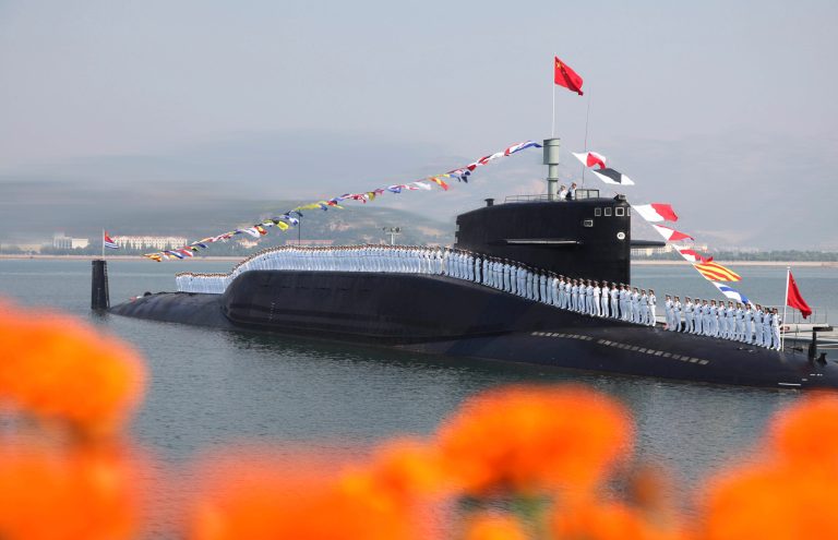 In this photo taken on Sept. 3, 2013 and released by the Chinese Navy on Sunday, Oct. 27, 2013, sailors line up on a Chinese nuclear submarine at the Qingdao submarine base in east China's Shandong province. (AP File)