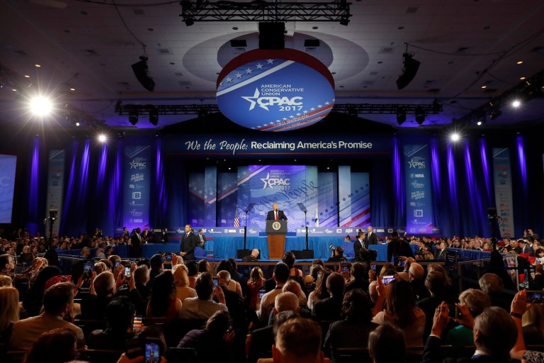 Trump joked that the audience had to sit down or the media would report that he didn't get a standing ovation. (AP Photo/Alex Brandon)