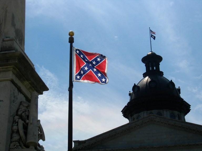 The flag no longer sits atop the capitol dome, but is still prominently displayed on the grounds. (Photo courtesy of flickr/Eyeliam)