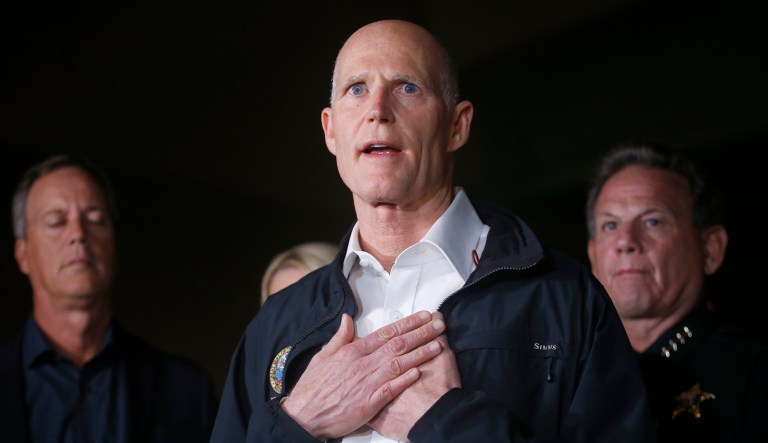 Florida Gov. Rick Scott (pictured center) said Friday he wants FBI Director Christopher Wray to step down. The comment comes after the FBI admitted they were contacted early last month by someone concerned with Nikolas Cruz's 