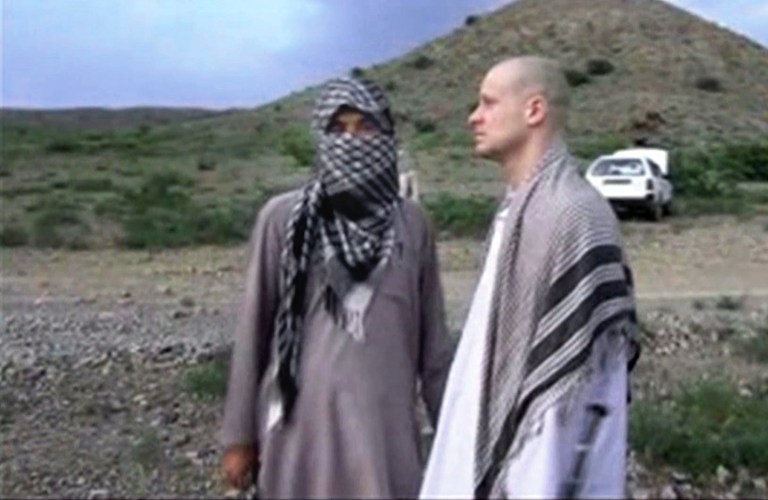 In this file image taken from video obtained from Voice Of Jihad Website, which has been authenticated based on its contents and other AP reporting, Sgt. Bowe Bergdahl, right, stands with a Taliban fighter in eastern Afghanistan. (AP Photo/Voice Of Jihad Website via AP video, File)
