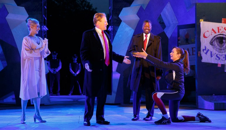 In this May 21, 2017 photo provided by The Public Theater, Tina Benko, left, portrays Melania Trump in the role of Caesar's wife, Calpurnia, and Gregg Henry, center left, portrays President Donald Trump in the role of Julius Caesar during a dress rehearsal of The Public Theater's Free Shakespeare in the Park production of Julius Caesar, in New York. Rounding out the cast on stage is Teagle F. Bougere as Casca, and Elizabeth Marvel, right, as Marc Anthony. (Joan Marcus/The Public Theater via AP)