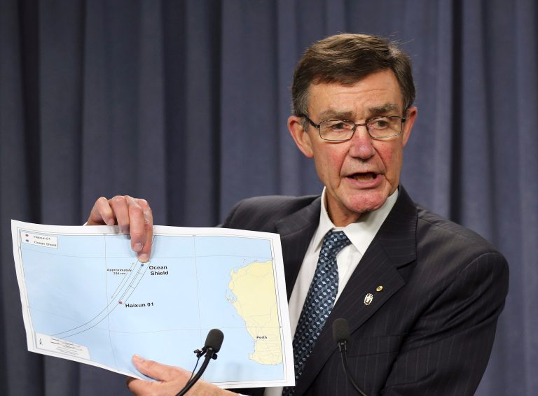 The chief coordinator of the Joint Agency Coordination Center retired Chief Air Marshall Angus Houston shows a map to the media during a press conference about the on going search operations for wreckage and debris of missing Malaysia Airlines Flight 370 in Perth,  Australia, Monday, April 7, 2014. Houston reported the towed pinger locator deployed from the Ocean Shield has detected two signals consistent with those emitted by an in flight back box recorder, in the northern part of the current search area in the southern Indian Ocean. (AP Photo/Rob Griffith)