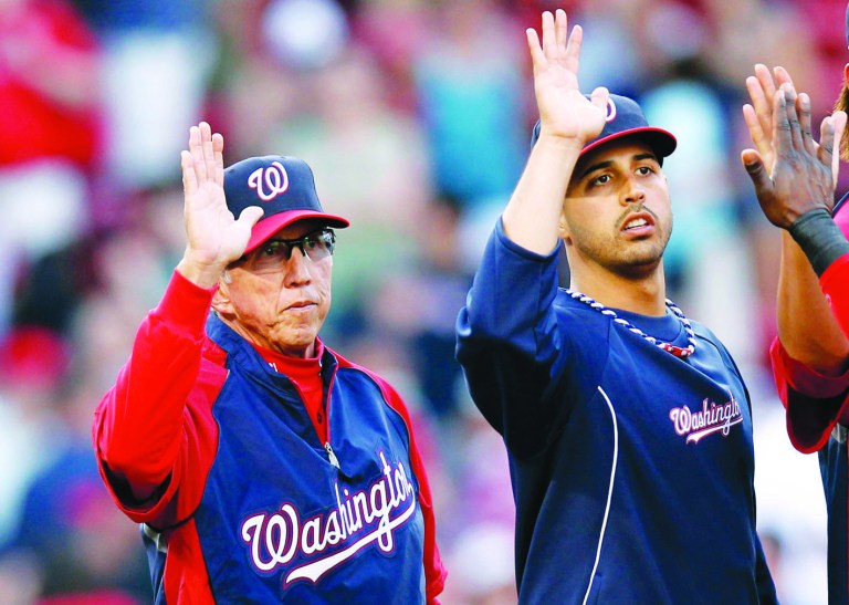 BOSTON, MA - JUNE 9:  Gio Gonzalez #47 of the Washington Nationals (R) and manager Davey Johnson #5 congratulate teammates after Washington's 4-2 win over the Boston Red Sox in interleague play at Fenway Park on June 9, 2012 in Boston, Massachusetts.  (Photo by Winslow Townson/Getty Images)