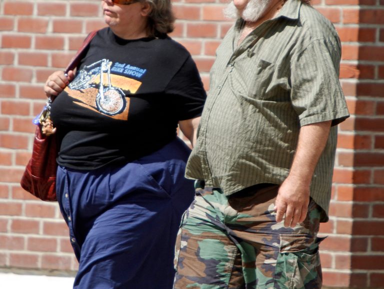 People walk on the street, Thursday, July 7, 2011, in Montpelier, Vt. National statistics show that Vermont is dropping from its perch near the top of national rankings of the least obese states. In 1995, 13.4 percent of Vermonters were considered obese. Now the figure is 23.5. (AP Photo/Toby Talbot)