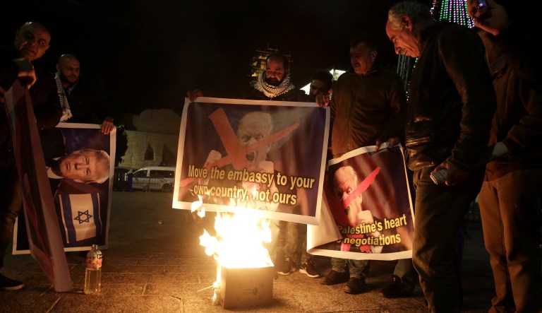 Palestinian burn a poster of President Trump during a protest in Bethlehem, West Bank, Tuesday, Dec. 6, 2017. (AP Photo/Mahmoud Illean)