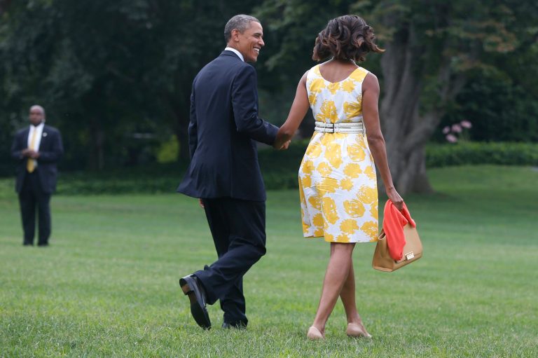   President Barack Obama and first lady Michelle Obama walk on the South Lawn at the White House in Washington, Saturday, Aug. 10, 2013, as they travel to Orlando, Fla. before heading to their vacation in Martha's Vineyard. (AP Photo/Charles Dharapak)  