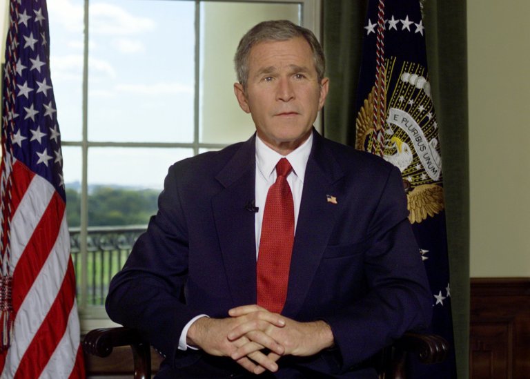 President Bush poses for a photo in the Treaty Room of the White House in Washington Sunday, Oct. 7, 2001, after announcing airstrikes on on Afghanistan. (AP/Hillery Smith Garrison)