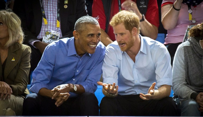 Former President Barack Obama and Britain's Prince Harry watch wheelchair basketball at the Invictus Games in Toronto. Harry said Meghan Markle and he 