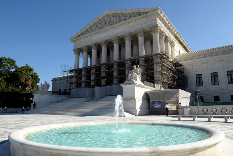 FILE - This Oct. 15, 2013, file photo shows the Supreme Court in Washington the day the court's justices said they would be reviewing whether or not the Environmental Protection Agency overstepped its authority in developing rules aimed at cutting emissions of six heat-trapping gases from factories and power plants.  Monday, Feb. 24, 2014, the Court will hear arguments on the unanimous federal appeals court ruling that upheld the government's unprecedented regulations aimed at reducing the gases blamed for global warming. (AP Photo/Susan Walsh, File)