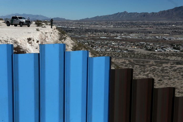 An agent of the border patrol, observes near the Mexico-US border fence, on the Mexican side, separating the towns of Anapra, Mexico and Sunland Park, New Mexico, Wednesday, Jan. 25, 2017. (AP Photo/Christian Torres)